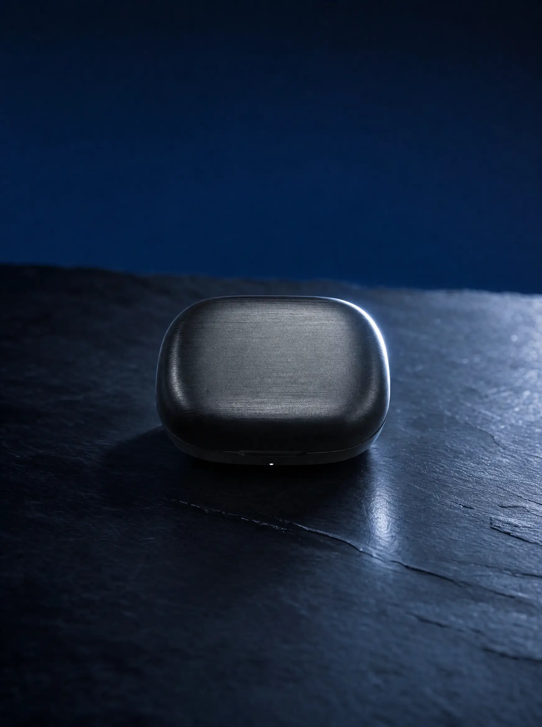 The same case on dark slate under a raking rim light